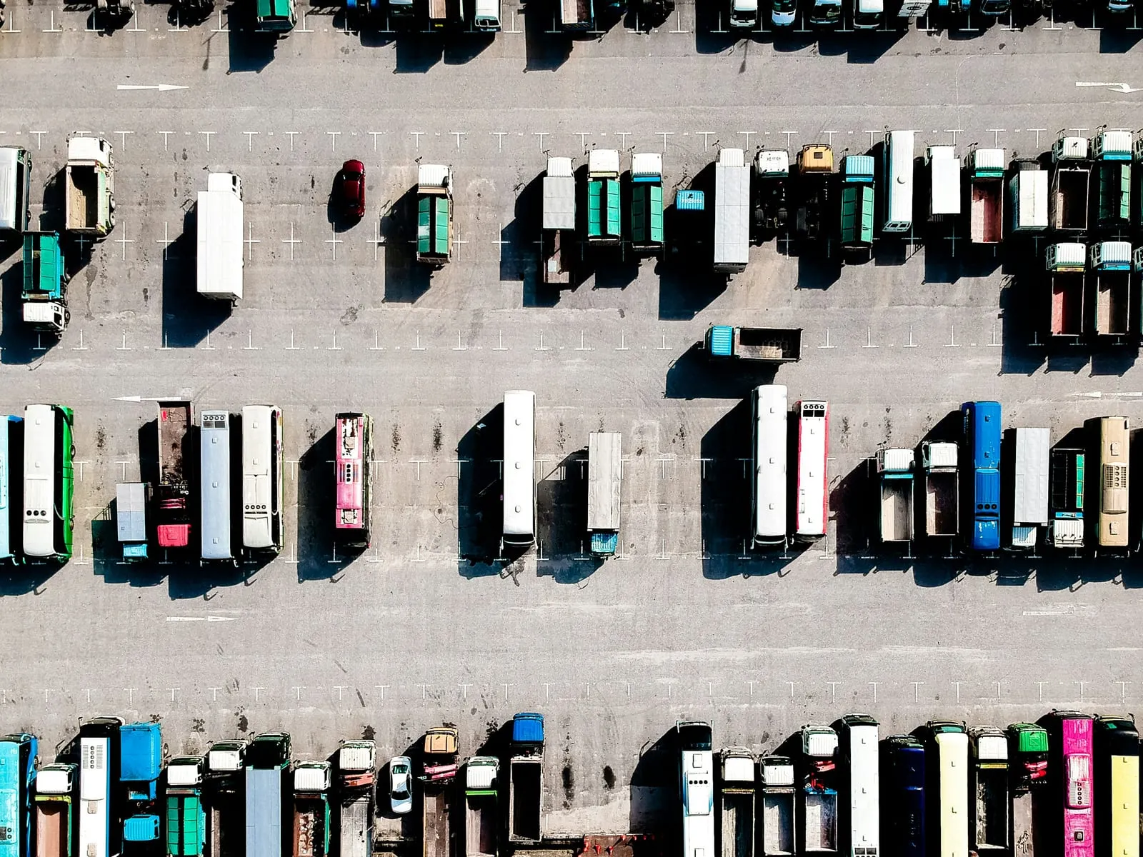 Aerial view of a fleet of trucks parked in rows