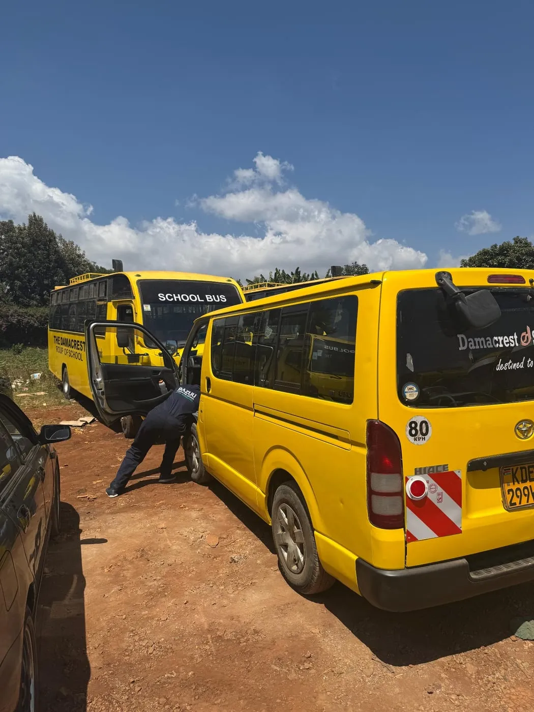 School buses being serviced in the field